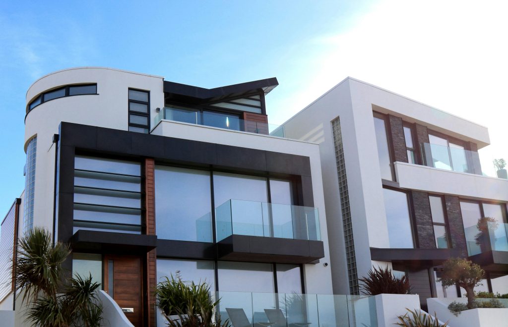 pexels-photo-323780-323780 Contemporary luxury home with glass balconies in Poole, UK, showcasing modern architectural design.